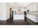 Bright kitchen with stainless appliances, white cabinets and an island at 5965 Hanover St, Denver, CO 80238