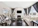 Bright living room with hardwood floors, fireplace, modern decor and large windows at 5965 Hanover St, Denver, CO 80238
