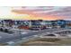 Beautiful neighborhood scene with sunset sky, showcasing modern homes and community spaces at 5965 Hanover St, Denver, CO 80238