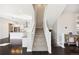 Open staircase with white railing adjacent to an open kitchen and hardwood floors at 5965 Hanover St, Denver, CO 80238