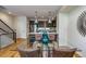 Stylish dining area with glass table and modern lighting adjacent to the open kitchen featuring stainless appliances at 3408 W 18Th Ave, Denver, CO 80204