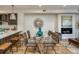 Dining area with glass table, modern chairs, pendant lighting, and adjacent kitchen at 3408 W 18Th Ave, Denver, CO 80204