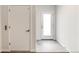 Clean foyer area with a white door and gray hexagon tile flooring at 3408 W 18Th Ave, Denver, CO 80204