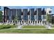 Modern townhomes with black and white exteriors, balconies, and well-maintained lawns at 3408 W 18Th Ave, Denver, CO 80204