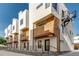 New townhome construction showing modern white exteriors with wood accents and patios at 3408 W 18Th Ave, Denver, CO 80204