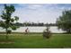 A serene scene of a cyclist riding along a picturesque path by a lake at 3408 W 18Th Ave, Denver, CO 80204