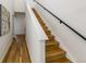 Modern staircase with hardwood steps and a sleek black railing at 3408 W 18Th Ave, Denver, CO 80204