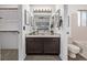 Well-lit bathroom with a double mirror vanity and an open view to the main bedroom at 7586 Halleys Dr, Littleton, CO 80125