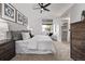 Cozy bedroom with a ceiling fan, comfortable bed, and walk-in closet access at 7586 Halleys Dr, Littleton, CO 80125