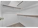 Spacious walk-in closet with wooden rods and neutral carpeting at 7586 Halleys Dr, Littleton, CO 80125