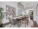 Modern dining room with stylish lighting, hardwood floors, and an open doorway to the living room at 7586 Halleys Dr, Littleton, CO 80125