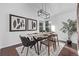 Modern dining room with stylish lighting, hardwood floors, and a decorative rug at 7586 Halleys Dr, Littleton, CO 80125