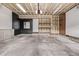 Unfinished garage featuring exposed beams, cement floor, and work area at 7586 Halleys Dr, Littleton, CO 80125