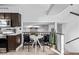 Eat-in kitchen features modern appliances and a dining area with a unique table and chair set at 7586 Halleys Dr, Littleton, CO 80125