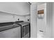 Laundry room featuring a washer, dryer, and shelving unit at 7586 Halleys Dr, Littleton, CO 80125