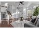 Bright living room featuring a vaulted ceiling, hardwood floors, staircase, and a comfortable couch at 7586 Halleys Dr, Littleton, CO 80125