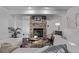 Cozy living room featuring a brick fireplace, stylish decor, and comfortable seating at 7586 Halleys Dr, Littleton, CO 80125