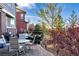 Landscaped backyard with a patio, seating, and a grill, ideal for outdoor entertaining at 27029 E Irish Pl, Aurora, CO 80016