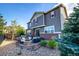 Inviting backyard with a stone patio, fire pit, and seating area, perfect for outdoor entertaining and relaxation at 27029 E Irish Pl, Aurora, CO 80016