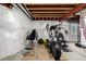 An unfinished basement featuring home gym equipment provides customization potential at 27029 E Irish Pl, Aurora, CO 80016