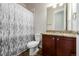 A functional bathroom has a vanity with a granite countertop and a shower and tub combo at 27029 E Irish Pl, Aurora, CO 80016