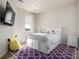 Bright bedroom with a chandelier, bed with storage, and a purple rug at 27029 E Irish Pl, Aurora, CO 80016