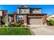 Beautiful two-story home featuring a brick facade, attached garage, and well-manicured lawn at 27029 E Irish Pl, Aurora, CO 80016