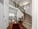 Grand foyer features a curved staircase with iron spindles, hardwood floors and an open view at 27029 E Irish Pl, Aurora, CO 80016