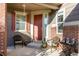 Inviting front porch featuring seating and decor creating a welcoming entrance at 27029 E Irish Pl, Aurora, CO 80016