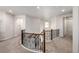 Upstairs hallway with wood railings, neutral walls, and abundant natural light at 27029 E Irish Pl, Aurora, CO 80016