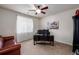Home office with a modern desk, multiple monitors, and a comfortable red leather couch at 27029 E Irish Pl, Aurora, CO 80016