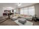 Bright living room with white sofa, and adjacent kitchen with granite counters at 27029 E Irish Pl, Aurora, CO 80016