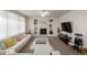 Cozy living room with a fireplace, built-in shelves, and comfortable seating at 27029 E Irish Pl, Aurora, CO 80016