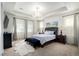 Spacious main bedroom boasts tray ceilings, large windows, and elegant furnishings at 27029 E Irish Pl, Aurora, CO 80016