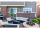 Back patio is perfect for entertaining with outdoor seating, a fire pit, and string lights at 27029 E Irish Pl, Aurora, CO 80016