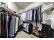 Organized walk-in closet featuring multiple clothing racks, shelving, and shoe storage at 27029 E Irish Pl, Aurora, CO 80016