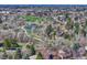 Scenic aerial view of a neighborhood with a lake, walking trails, and lush greenery, highlighting the natural beauty of the community at 7444 S Milwaukee Ct, Centennial, CO 80122