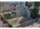 Aerial view of a fenced backyard featuring mature trees and a well-maintained lawn, ideal for privacy and outdoor enjoyment at 7444 S Milwaukee Ct, Centennial, CO 80122