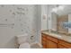 Charming bathroom with a decorative mirror, wooden vanity and whimsical wall decor at 7444 S Milwaukee Ct, Centennial, CO 80122