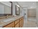 Bathroom featuring double sinks, granite countertops, a spacious shower and a separate toilet room at 7444 S Milwaukee Ct, Centennial, CO 80122