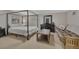 Bedroom with a four-post bed frame, carpeted floor, and rustic wood coffee table at 7444 S Milwaukee Ct, Centennial, CO 80122