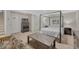 Bedroom featuring a four-poster bed frame, a rustic wood coffee table, and a neutral color palette at 7444 S Milwaukee Ct, Centennial, CO 80122