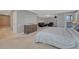 Large bedroom featuring an ensuite bathroom, sitting area with a fireplace, and access to the balcony at 7444 S Milwaukee Ct, Centennial, CO 80122
