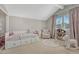 Comfortable bedroom with a daybed, rocking horse, plush rug and a window with natural light at 7444 S Milwaukee Ct, Centennial, CO 80122