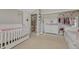 Cozy bedroom with white furniture, closet and a safety gate at the doorway at 7444 S Milwaukee Ct, Centennial, CO 80122