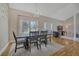 Elegant dining room featuring hardwood floors, natural light, and a stylish rug creating a cozy atmosphere at 7444 S Milwaukee Ct, Centennial, CO 80122