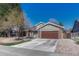 Beautiful home exterior featuring a well-kept lawn, mature trees, and a two-car garage, showcasing its curb appeal at 7444 S Milwaukee Ct, Centennial, CO 80122