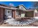 Charming front entrance with brick accents, a cozy porch, and a well-maintained walkway, creating a welcoming curb appeal at 7444 S Milwaukee Ct, Centennial, CO 80122