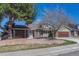 Charming home featuring mature landscaping, brick accents, and a welcoming front entrance, creating inviting curb appeal at 7444 S Milwaukee Ct, Centennial, CO 80122