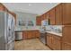 Bright kitchen featuring stainless steel appliances, light countertops, and ample cabinet space, perfect for cooking at 7444 S Milwaukee Ct, Centennial, CO 80122